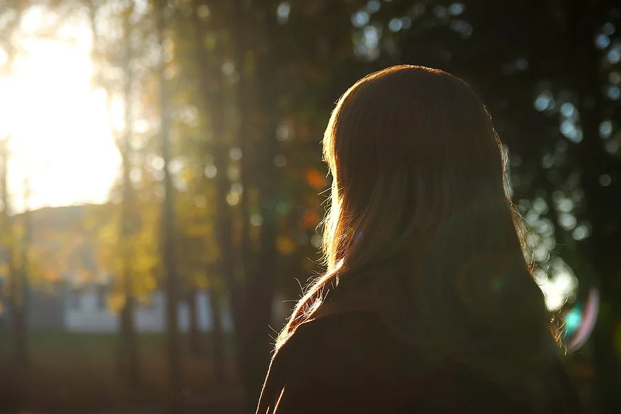  Woman looking out at the distance into the trees. Trauma therapy in Austin, TX can help you find hope again. A holistic trauma therapist near Austin, TX can help via online therapy in Texas and yoga therapy here. 78733 | 78730 | 78738 