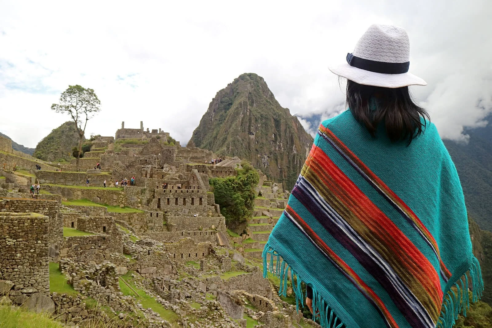  Woman stands looking at ancient ruins in Mexico with her back to the camera wearing a teal and orange striped poncho and a hat. Healing from your past with a trauma therapist in Austin, TX takes time. Trauma therapy in Texas can help you move past your pain. Online therapy in Texas can help! 