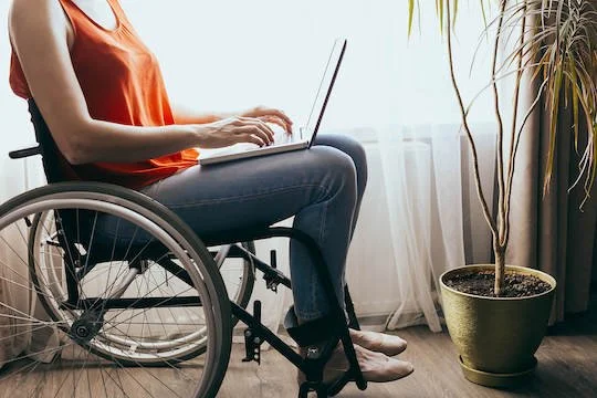  Person sitting in wheelchair near a window and typing on computer. (75219, 75022) We have holistic therapists available to help you with anxiety, depression, and grief via online therapy in Texas. 