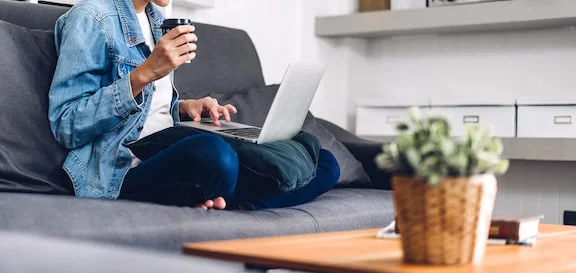  Person sitting on a couch with a cup of coffee and typing on a computer. (75205, 75201, 75225) Get connected with a holistic therapist for help with anxiety, grief, depression, and more via online therapy in Texas. 
