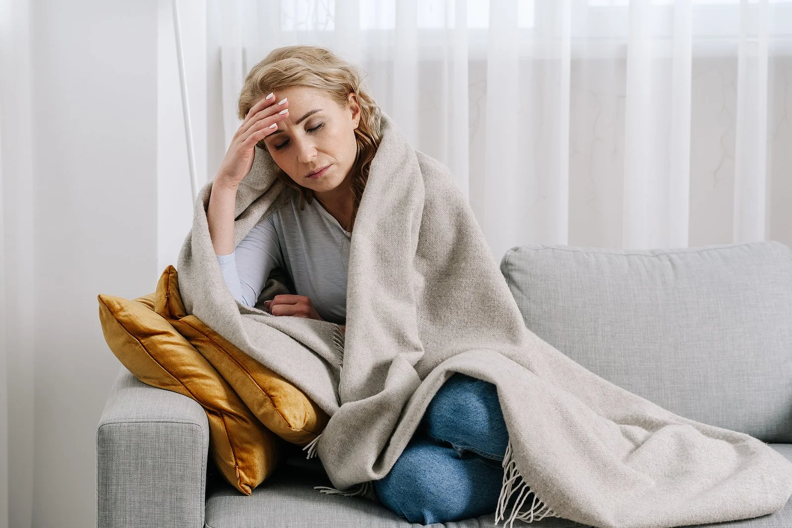  Photo of a middle aged woman holding her head representing the stress and anxiety a person may feel before calling a therapist. If you life in the Austin, TX area, I can help with eating disorder treatment, trauma therapy, counseling for stress, anxiety treatment & other mental health support. 
