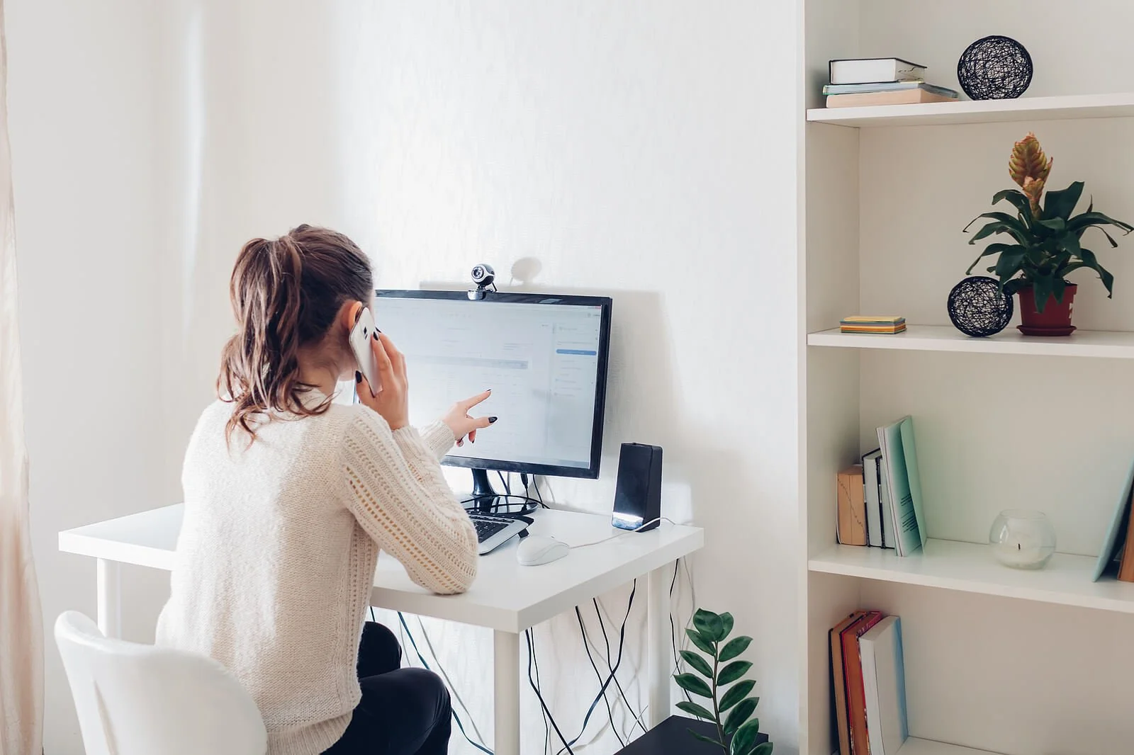 Woman on a computer while talking on the phone. Anxiety symptoms can keep you from living life, but anxiety treatment in Austin, TX can help you cope. Get help from an anxiety therapist near you with online therapy in Texas serving Dallas, Houston, Austin and beyond.