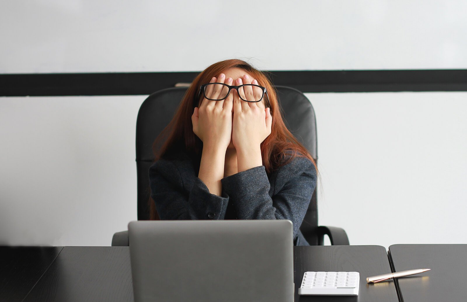  Woman overwhelmed with anxiety at work with her hands on her face. If you are struggling with anxiety in the workplace that is making your work life difficult? Anxiety therapy online in Utah and Texas is here to help you regain peace. 84098 - 84004 