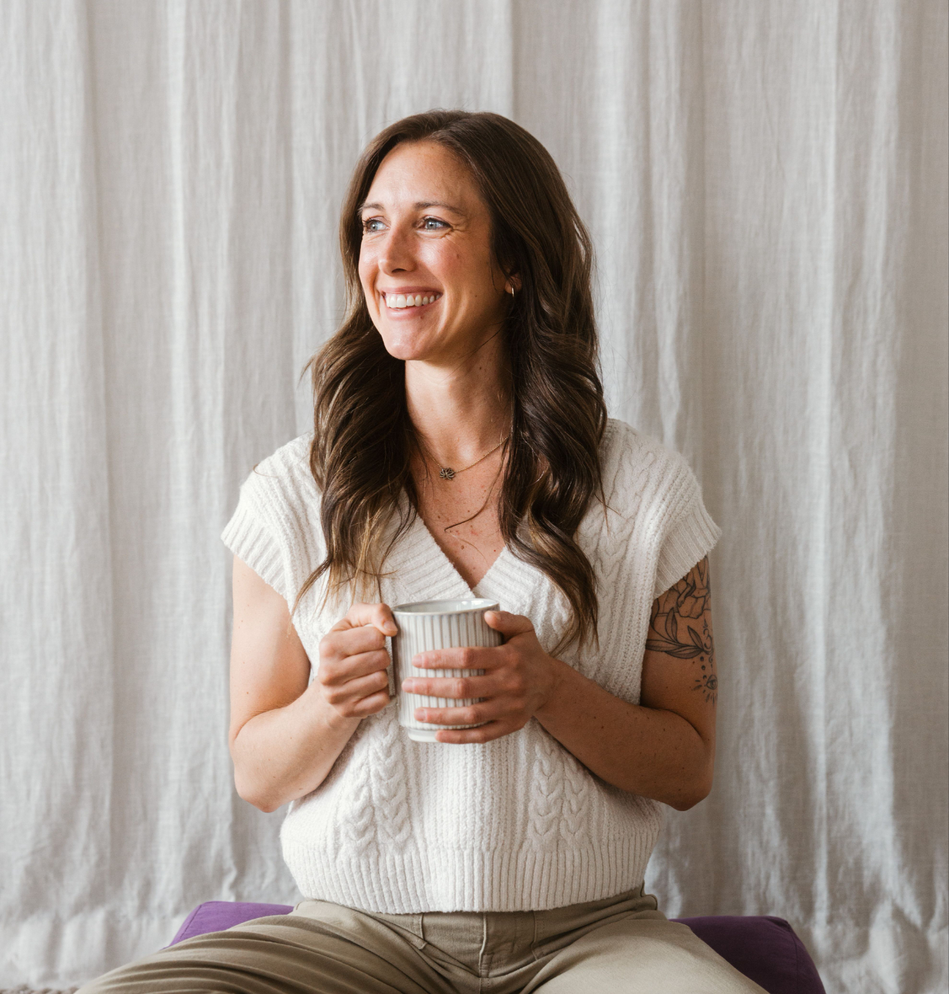 Grace Secker holding a mug, smiling